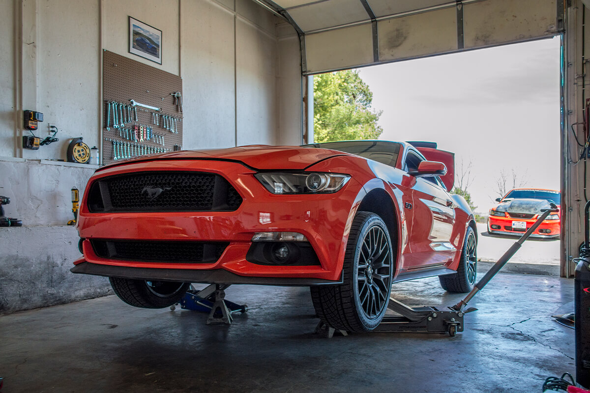 working on s550 competition orange mustang